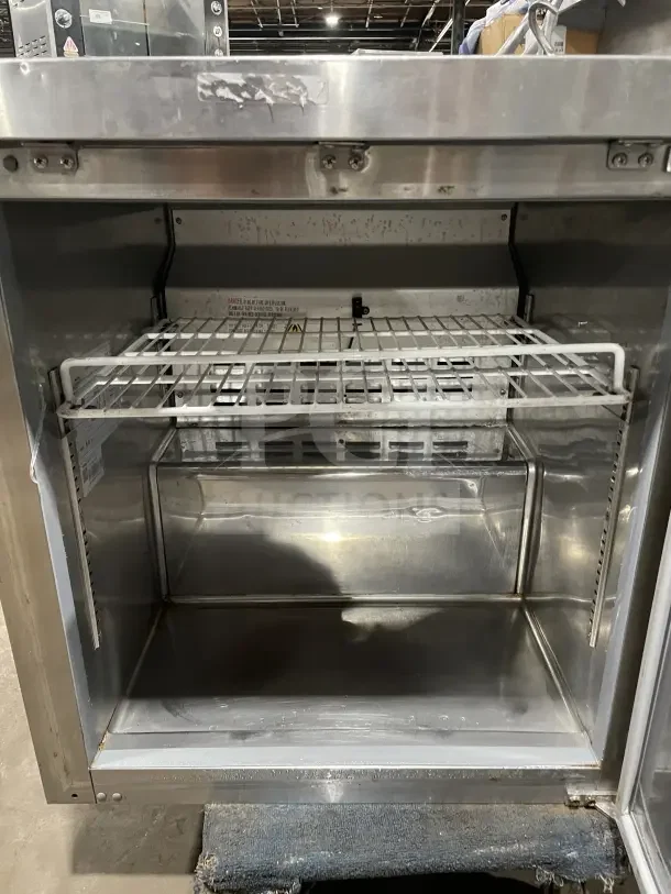 Coldline 27" undercounter stainless steel refrigerator, model UUC-27R-HC, includes poly-coated wire rack, used condition.