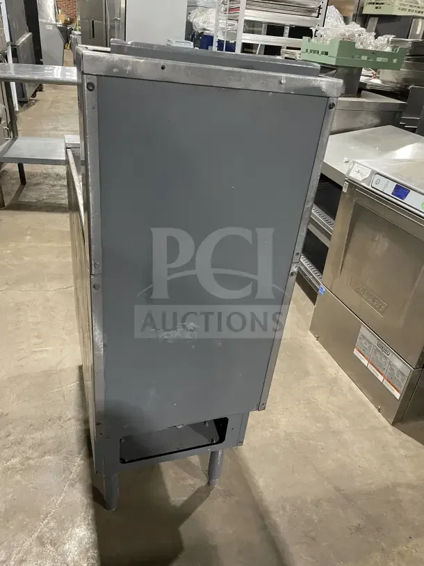 Pitco SFSG14 JS 40 lb. stainless steel natural gas fryer with backsplash, basket hanger, and fry basket; on legs.