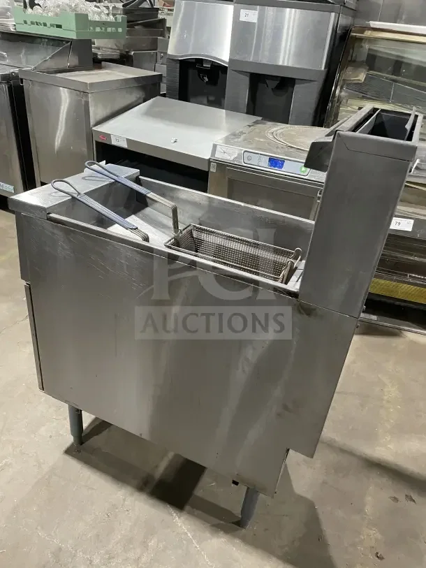 Pitco 40 lb. stainless steel gas fryer, model SFSG14 JS, with backsplash, basket hanger, and fry basket, on legs.