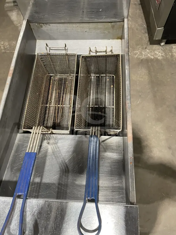 Pitco SFSG14 JS stainless steel 40 lb. deep fat fryer with backsplash, basket hanger, and fry baskets. Used condition.