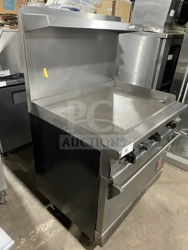 Wolf commercial stainless steel gas stove, 4 burners, with backsplash and sides, on casters, good condition.