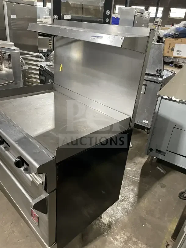 Wolf commercial stainless steel gas range, 4 burners, with back and sides on casters, in good condition.