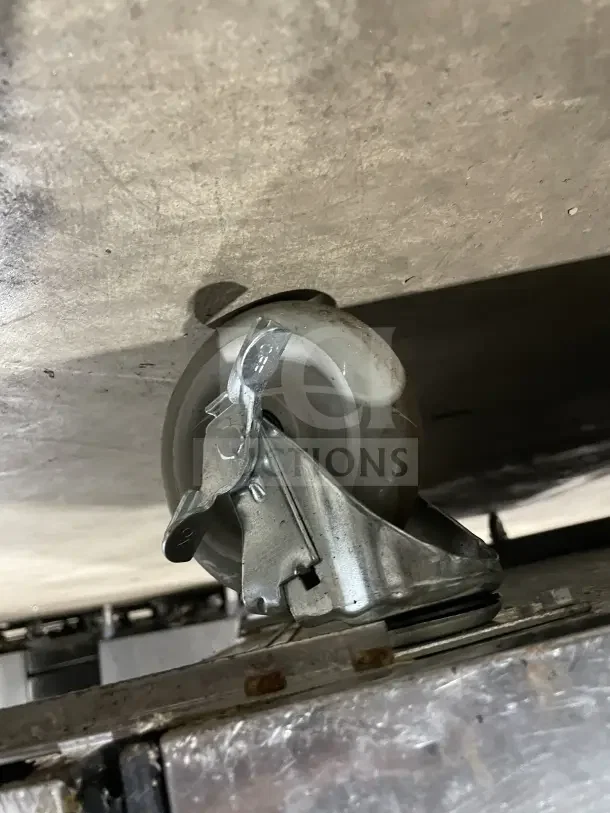 True SSU-72-08 S refrigerated prep table wheel, highlighting caster design and condition. Visible metal frame and wheel lock mechanism.
