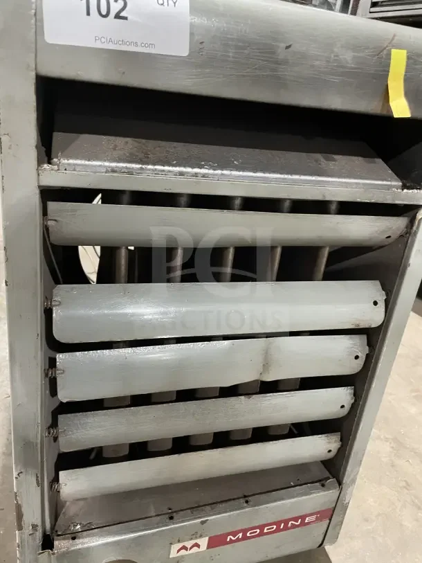 Modine PA Series stainless steel gas-fired heater with louvers, label, and visible wear. Suitable for industrial use.
