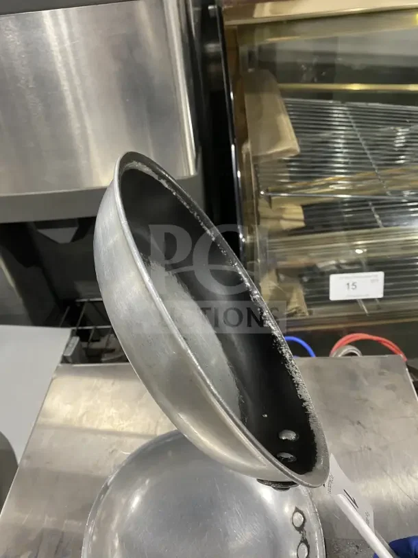 Commercial aluminum non-stick fry pan with handle, used condition. Features riveted handle, ideal for professional kitchens.