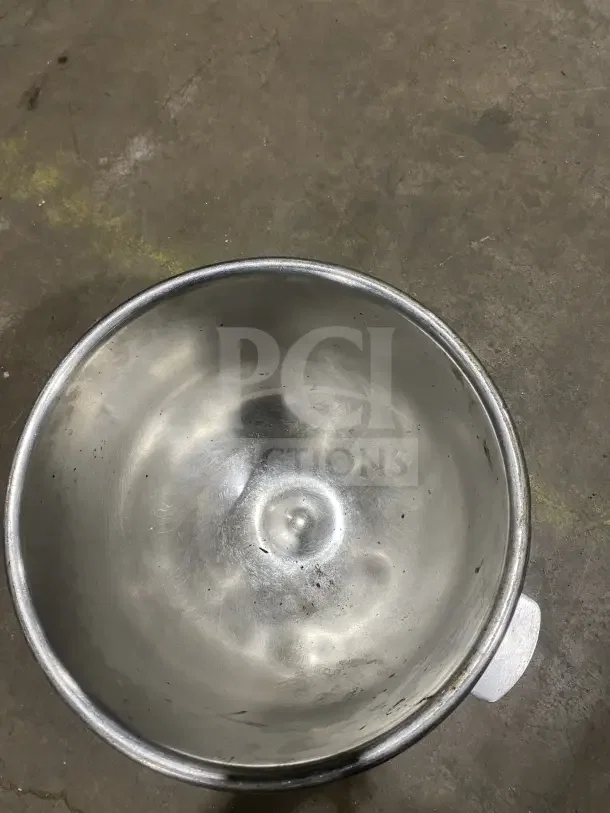 Commercial stainless steel 30 qt planetary mixing bowl, used condition, visible wear inside, sturdy construction.