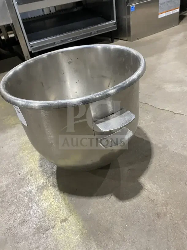 Commercial 30 Qt stainless steel planetary mixing bowl. Features sturdy handles, minor surface wear. Ideal for heavy-duty use.