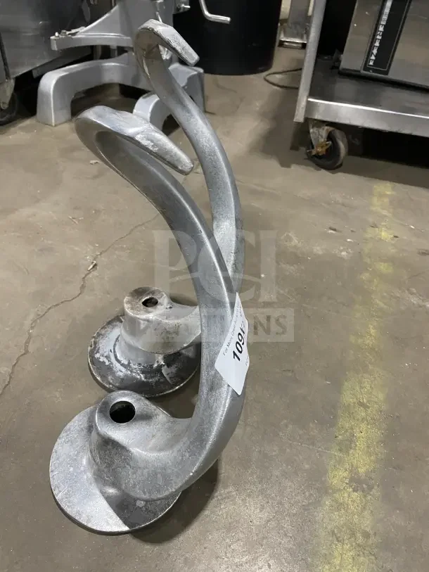 Stainless steel spiral dough hooks for 60Qt mixers, worn condition, includes two hooks, auction tag visible.