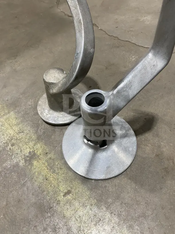 Commercial stainless steel spiral dough hooks, heavy-duty, used condition, visible wear, set of two, durable construction.