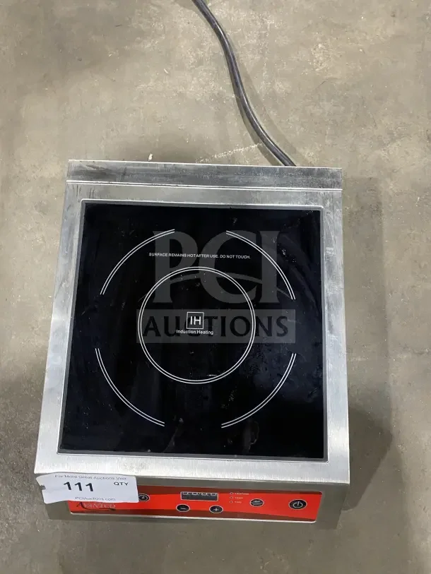 Avantco IC3500 induction range, stainless steel, countertop model, 208-240V, clear control panel, minor wear, auction tag visible.