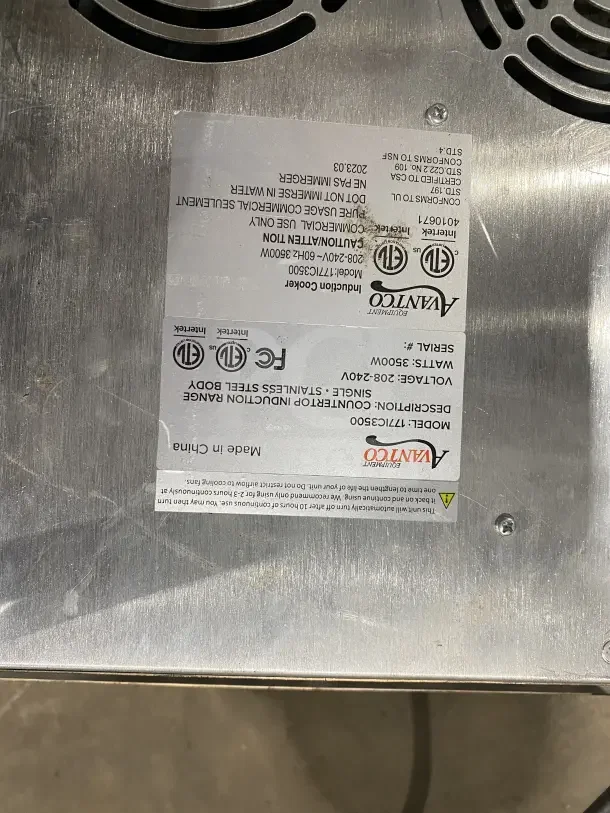Avantco Induction Range IC3500, stainless steel, 208-240V, heavy-duty, label showing specifications and safety warnings.