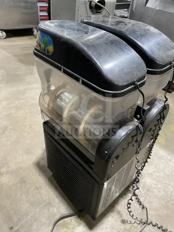 Omega OFS20 slushie dispenser, 2 flavors, 120V1, used condition, visible wear, serial 2FS16100006, clear tanks, black lids.