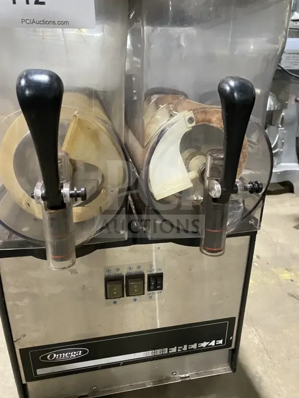 Omega OFS20 commercial countertop slushie dispenser, 2 flavors, model 2FS16100006, 120V1, used condition, Omega branding visible.