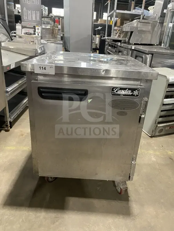Leader stainless steel single-door undercounter refrigerator with poly-coated wire rack and casters, in good condition.