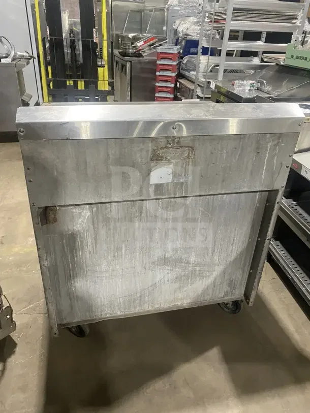Jade Bistro stainless steel gas charbroiler with open cabinet base on casters. Used condition, commercial kitchen equipment.