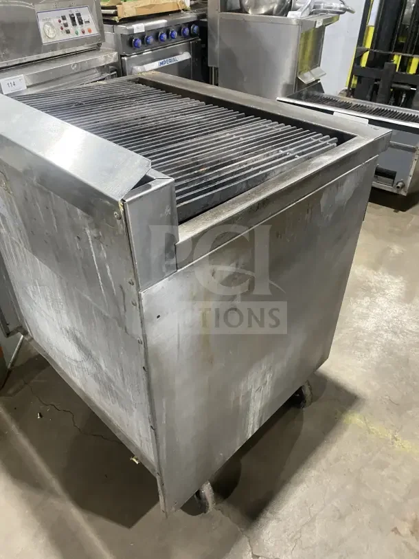 Jade Bistro stainless steel gas charbroiler with open cabinet base, on casters. Visible wear, control panel intact.