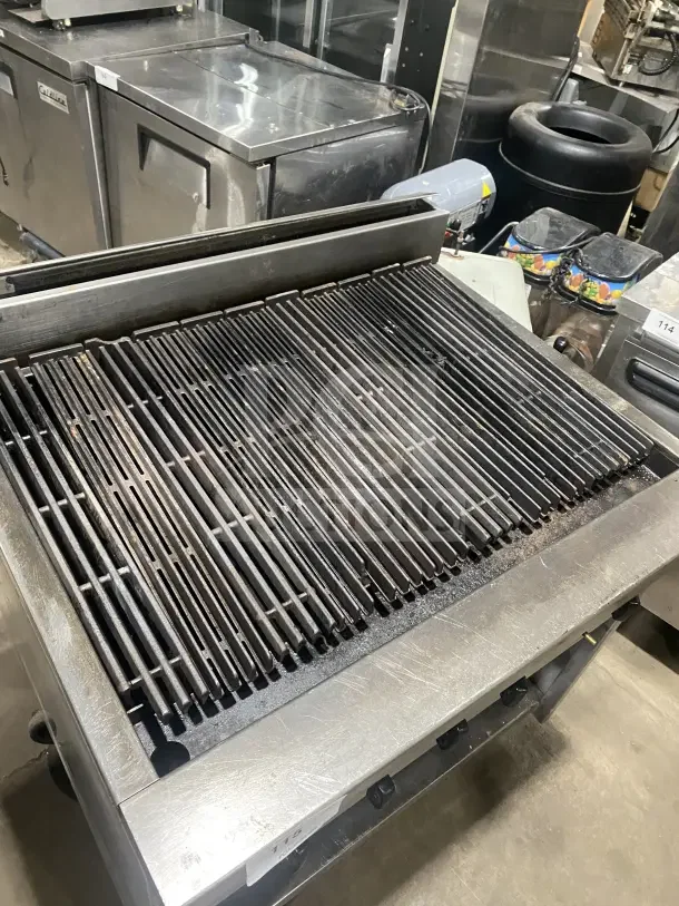 Jade Bistro stainless steel gas charbroiler with open cabinet base. Features include casters and adjustable grates.