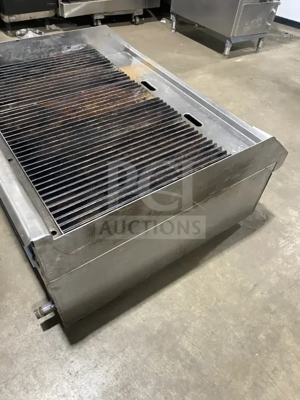 Southbend stainless steel gas charbroiler with back and side splashes, showing grill grates. Used condition.