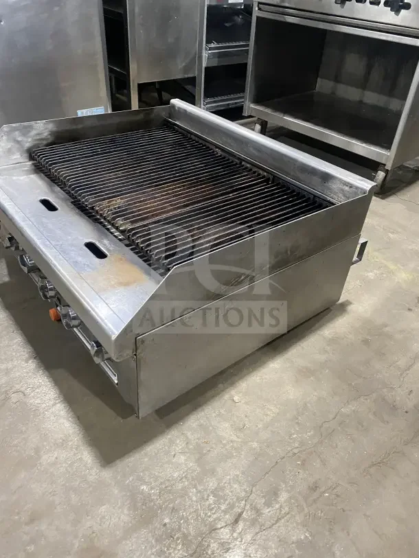 Southbend stainless steel gas countertop charbroiler with back and side splashes, visible dials, good used condition.