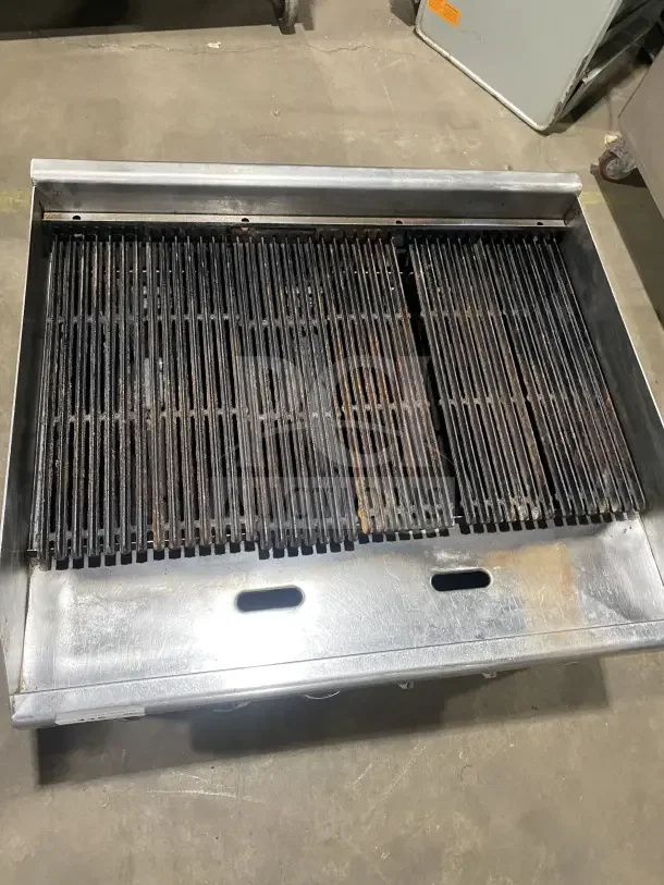 Southbend commercial stainless steel gas charbroiler with back and side splashes. Used, with rust on grill.