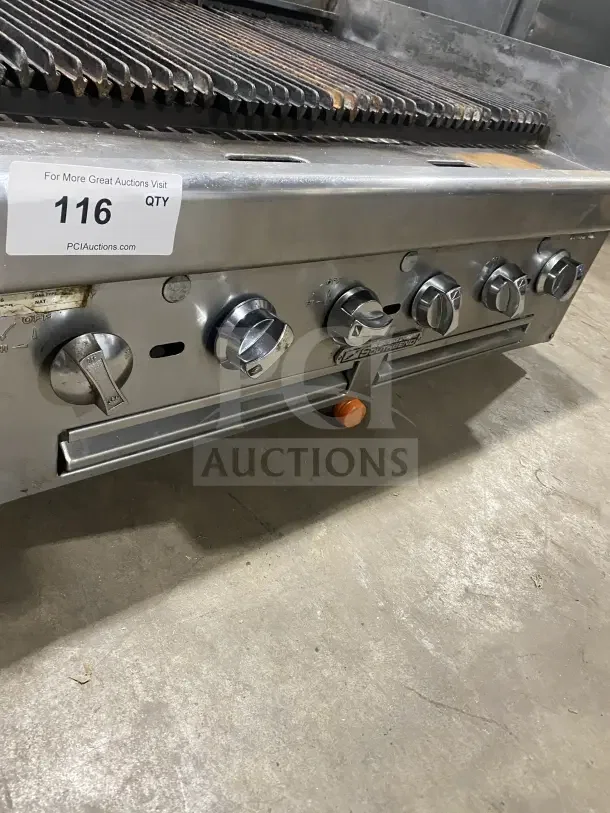 Southbend stainless steel gas charbroiler with back and side splashes, five control knobs, auction tag visible.