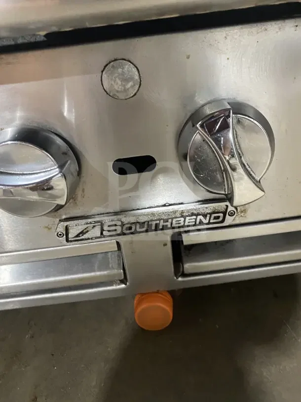 Southbend Commercial Stainless Steel Gas Charbroiler with controls and logo. Features back and side splashes.