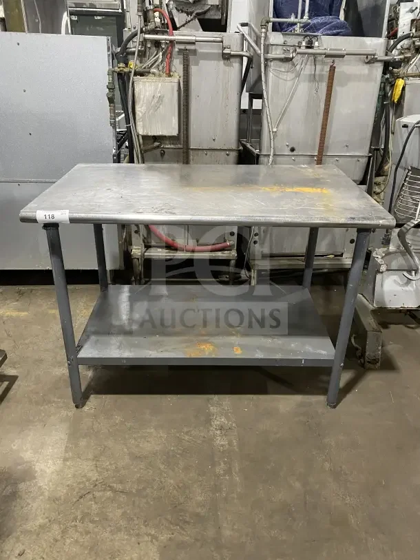 Commercial stainless steel utility stand with 2 compartments, visible wear and rust. Measures approximately 4 feet in length.