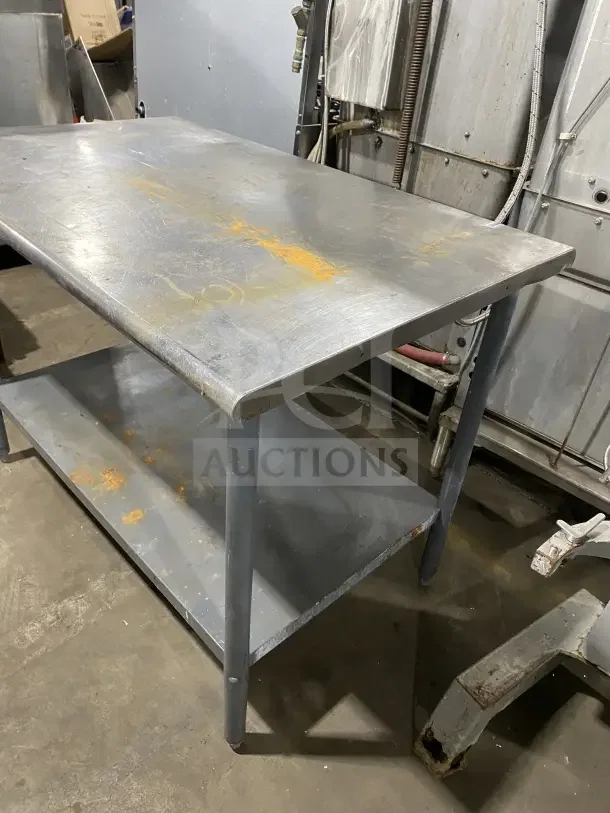 Commercial stainless steel utility stand with two compartments, showing surface wear and patina, durable design.