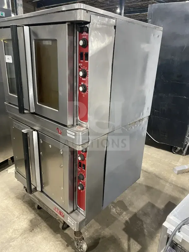 Blodgett stainless steel double stacked electric convection oven with wired rack, on legs and casters.