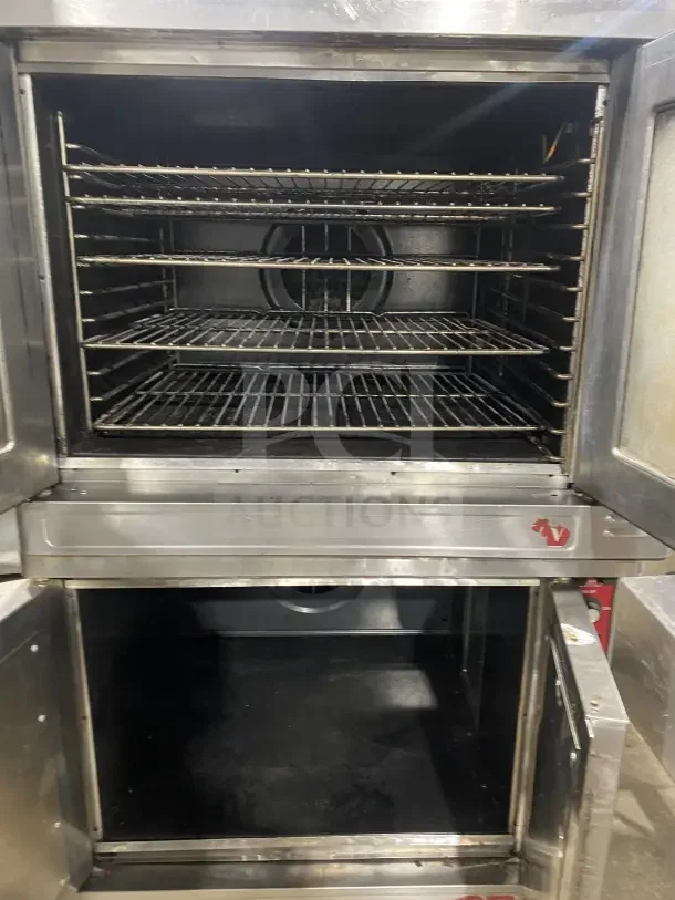 Blodgett stainless steel double-stacked convection oven with wired rack, on legs and casters. Electric-powered. Fair condition.