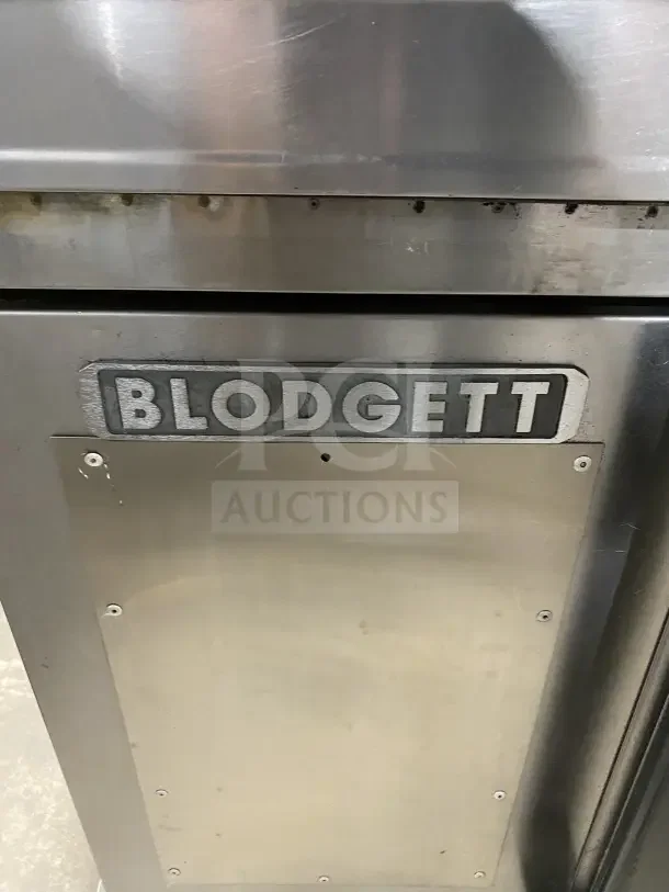 Blodgett stainless steel double convection oven, on casters, with wired rack. Visible brand logo on front. Used condition.