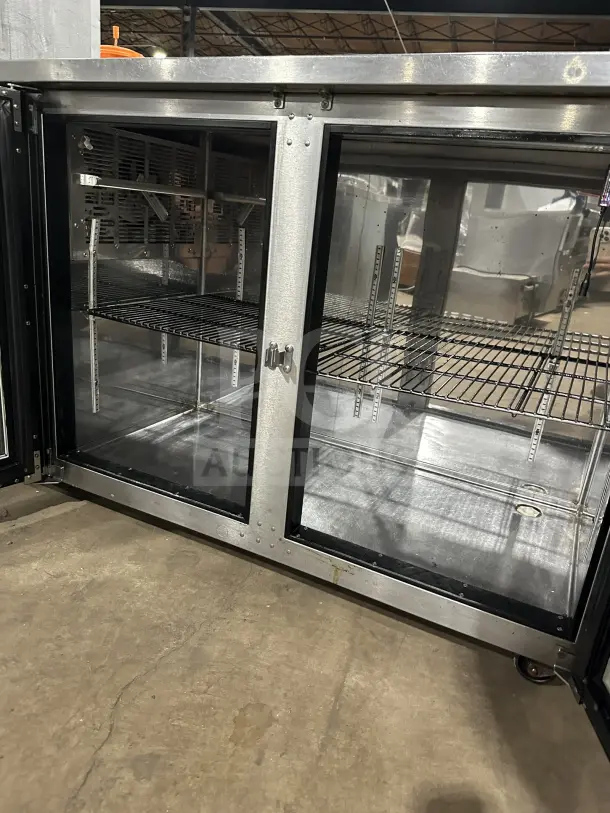 Perlick model BBS60 glass 2-door stainless steel bar cooler with chrome wire rack and casters, excellent condition.