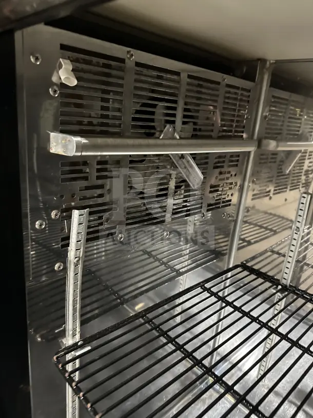 Perlick BBS60 commercial stainless steel glass 2-door bar back cooler; chrome-plated wire rack; on casters. Model BBS60-RM.
