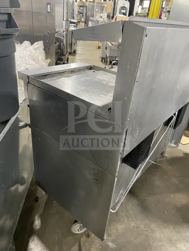 Sunfire stainless steel gas range with 6 burners, side griddle, and 2 ovens. Includes wire rack and casters.