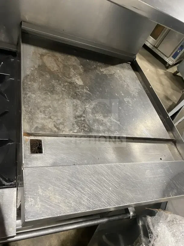 Sunfire stainless steel gas range with 6 burners, side griddle, 2 ovens, oven wire rack, on casters. Commercial-grade.