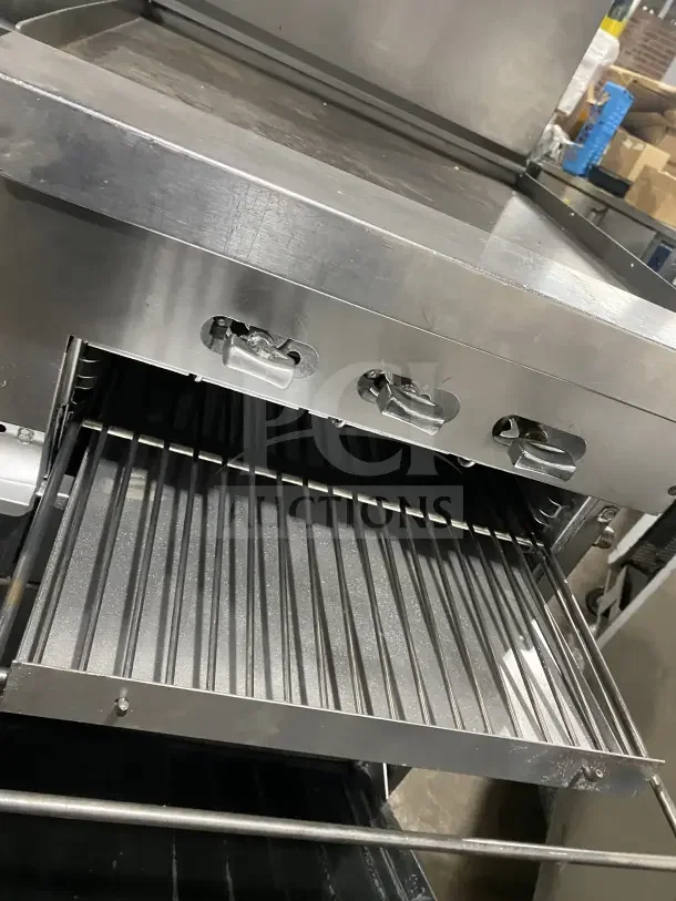 Sunfire stainless steel commercial gas range with 6 burners, side griddle, 2 ovens, wire rack, and casters.