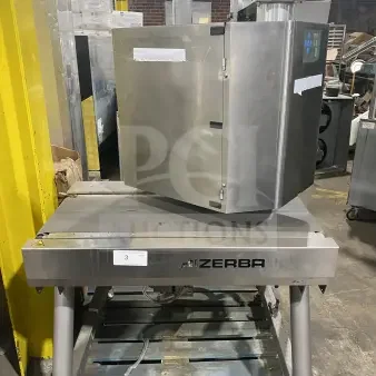 Bizerba commercial stainless steel weigh price labeling machine with digital push controls, mounted on legs; industrial setting.