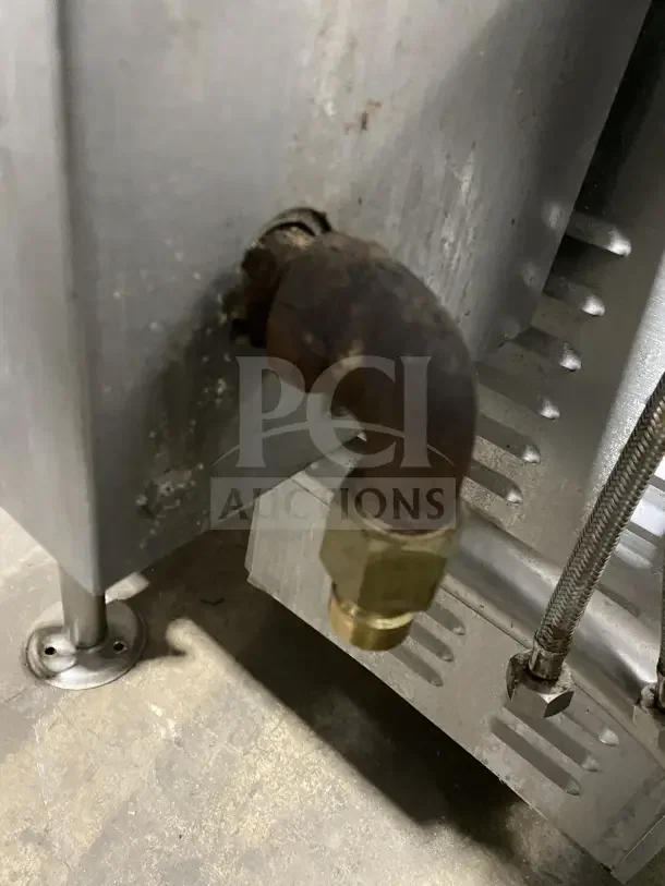 Cleveland Range Enodis KGL-40-T commercial steam kettle connection, showing rust and wear on the gas pipe and leg.