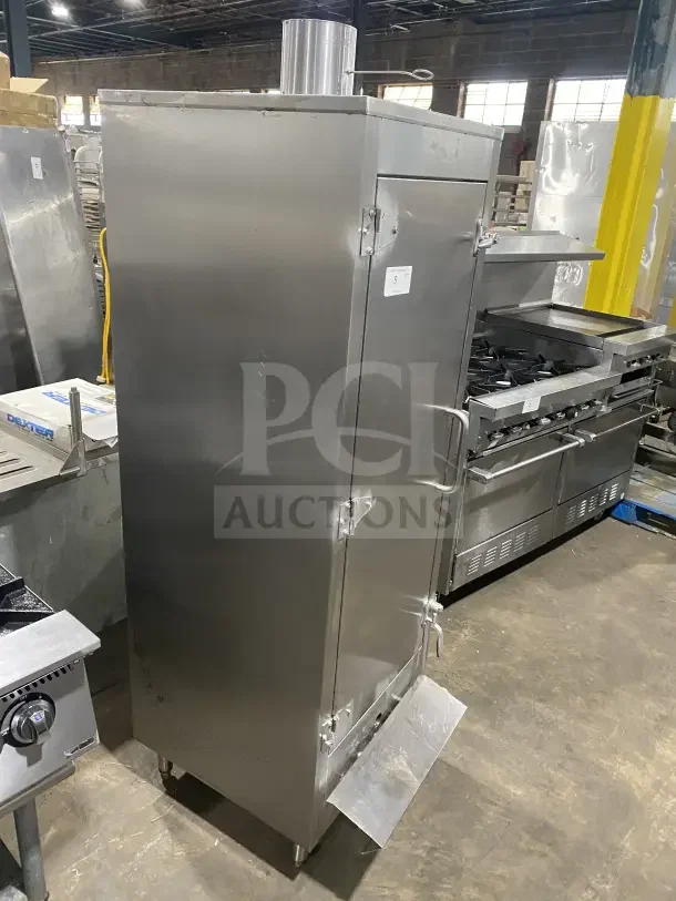 Commercial stainless steel vertical gas-powered smokehouse oven, BBQ meat smoker on casters, in good condition.