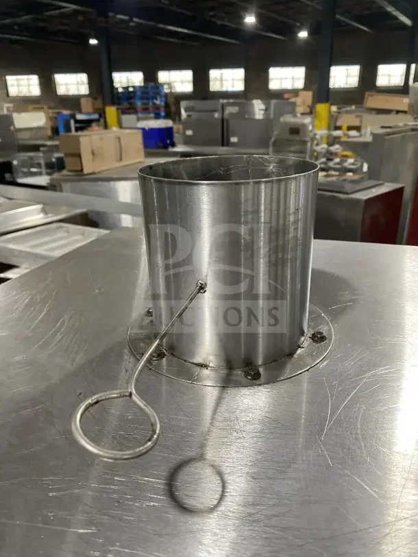 Commercial stainless steel vertical gas-powered smokehouse oven with casters. Features a sturdy design and smoke vent.