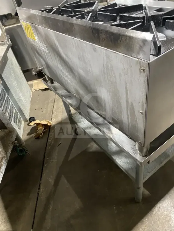 UltraMax Model 806HA stainless steel 6-burner gas hot plate, used condition, on a stainless steel equipment stand.