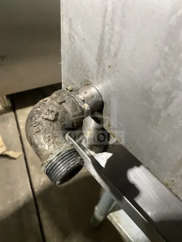 Close-up of piping on an UltraMax 806HA 36" stainless steel countertop hot plate with signs of wear.
