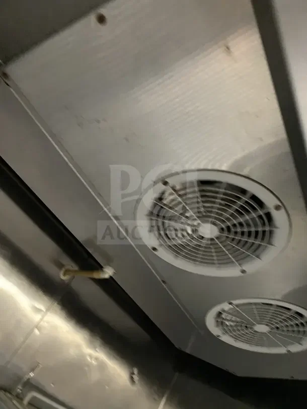 Alt text: Interior of Atosa MCF8707 refrigerator showing stainless steel walls, cooling fan, and wiring.