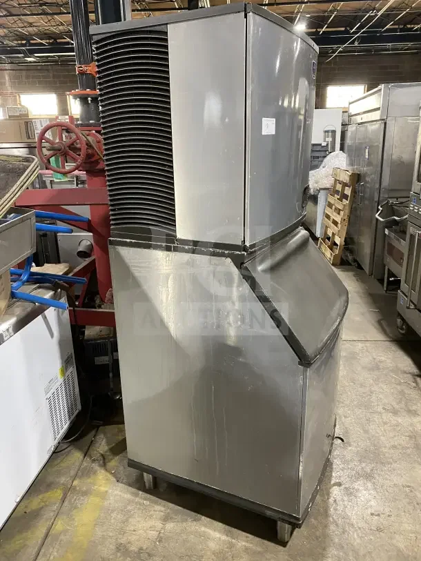 Manitowoc stainless steel ice maker/bin combo, model IY1106A-261, electric, air-cooled, on legs, used condition.