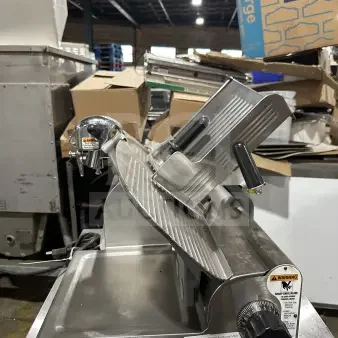 Chefmate Globe Series commercial deli meat slicer, stainless steel, electric powered, gravity feed, mounted on legs.