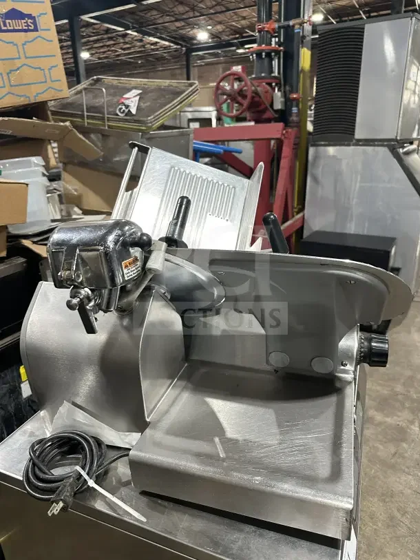 Chefmate Globe Series stainless steel deli meat slicer, electric-powered, gravity feed, countertop model on legs, used condition.