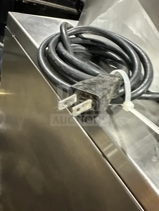 Chefmate Globe Series deli meat slicer electric cord, showing plug and coiled cable, on stainless steel surface.