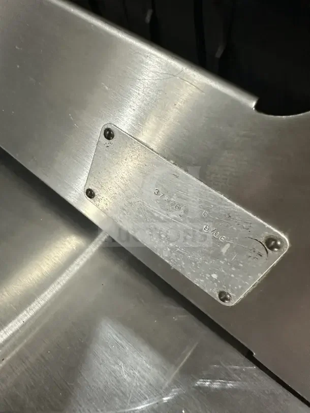 Chefmate Globe Series stainless steel deli meat slicer with visible metal plate and markings, in good condition.