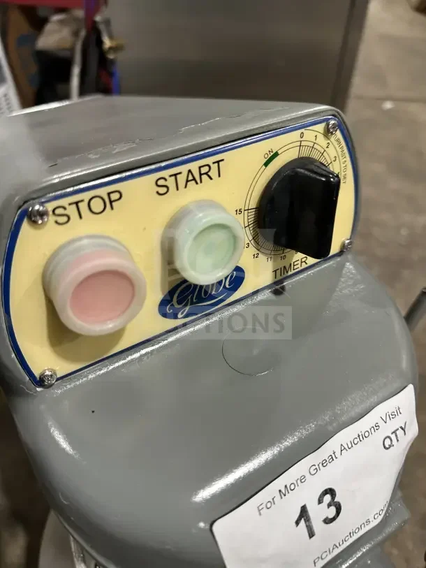 Globe commercial countertop heavy-duty planetary mixer with stainless steel bowl and guard. Features start/stop buttons and timer.