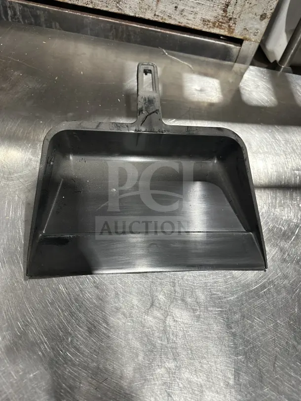 Black plastic commercial ice scoop by Continetal on stainless steel surface, new condition, heavy-duty design.